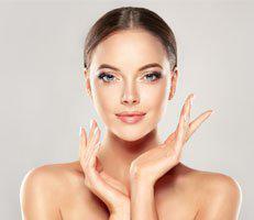 Woman smiling after liquid face lift treatment at Advanced Rejuvenation Center.