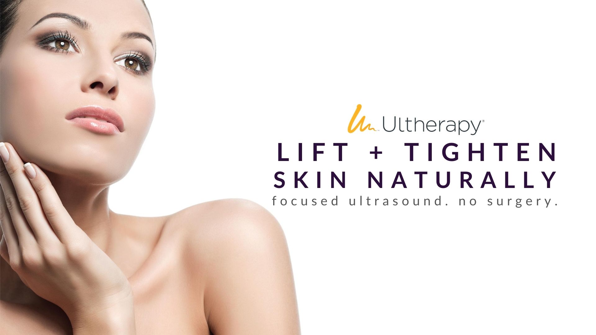 Woman touches her lifted + tightened skin with natural looking results from ultherapy treatment at advanced rejuvenation centers.