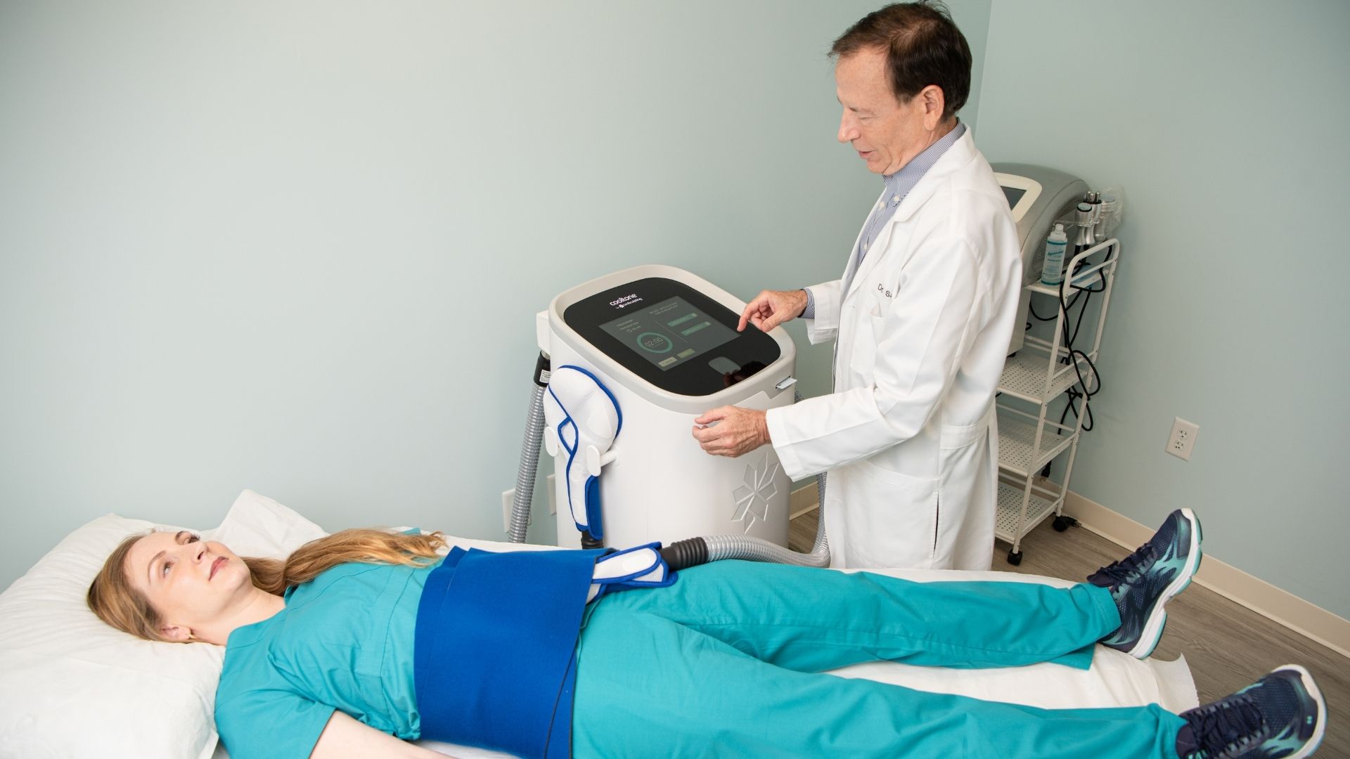 Woman receiving cooltone treatment from the staff at advanced rejuvenation centers.
